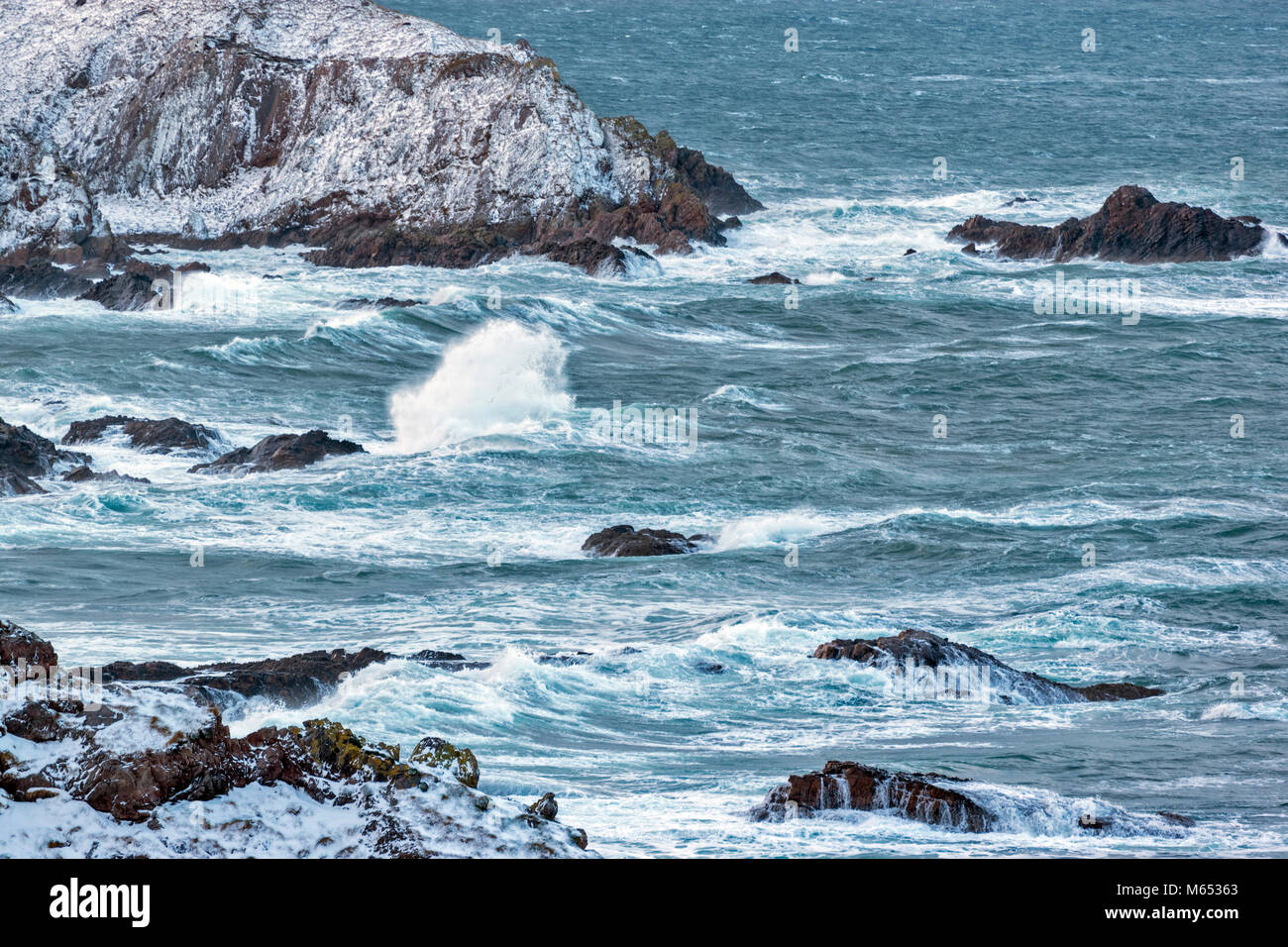 MORAY COAST SCOTLAND PORTKNOCKIE  IN FEBRUARY WINTER STORM WITH HIGH WINDS LARGE WAVES SPRAY AND SNOW Stock Photo