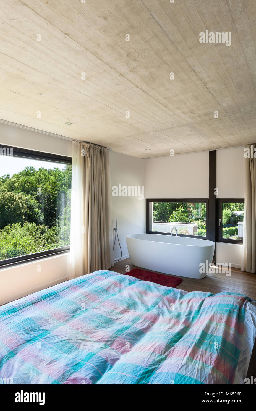 Modern villa, interior, bedroom with bathtub Stock Photo - Alamy