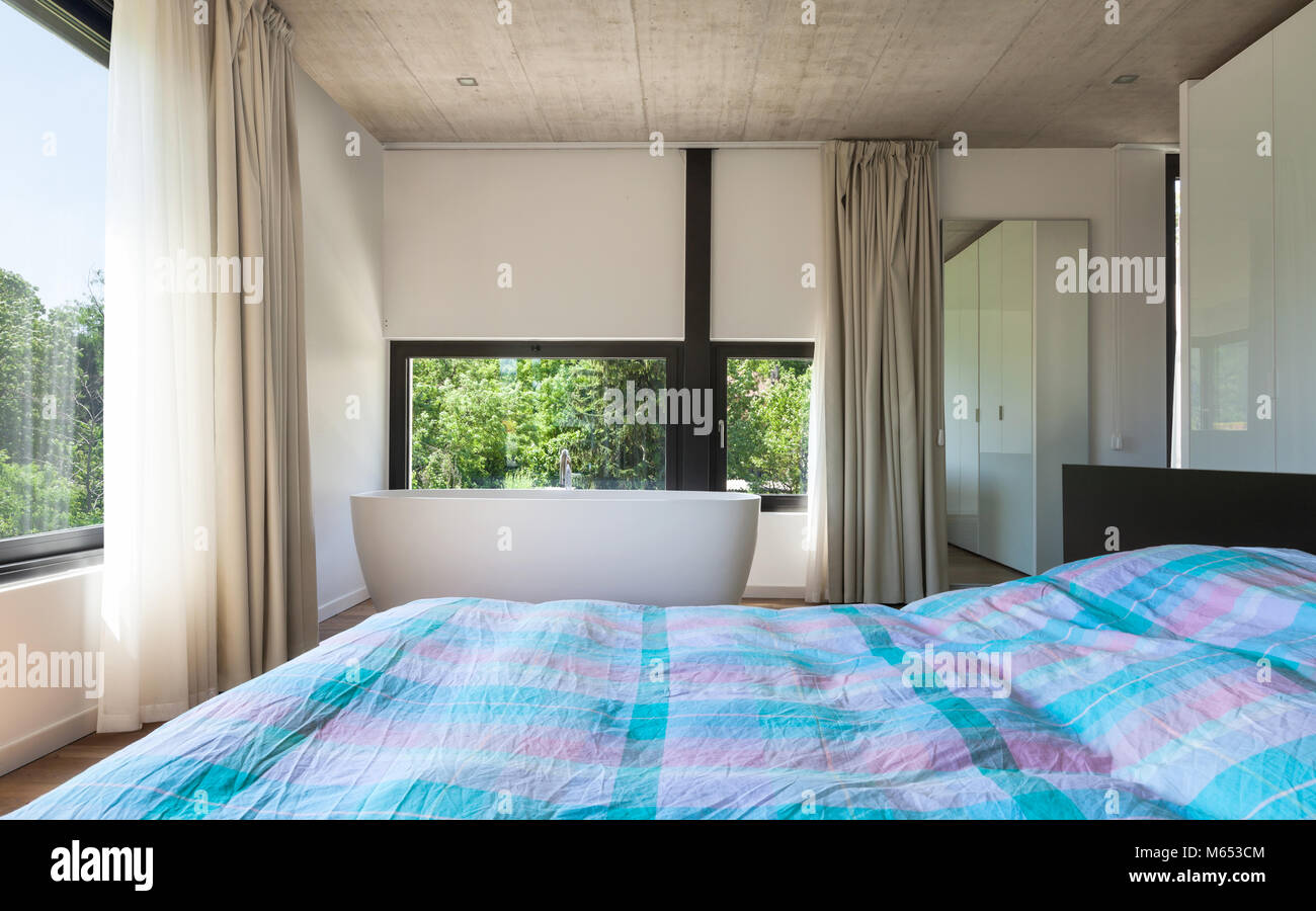 Modern villa, interior, bedroom with bathtub Stock Photo - Alamy