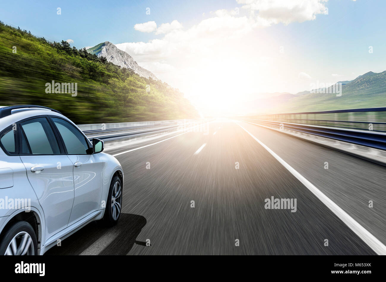 A white car rushing along a high-speed highway in the sun Stock Photo ...