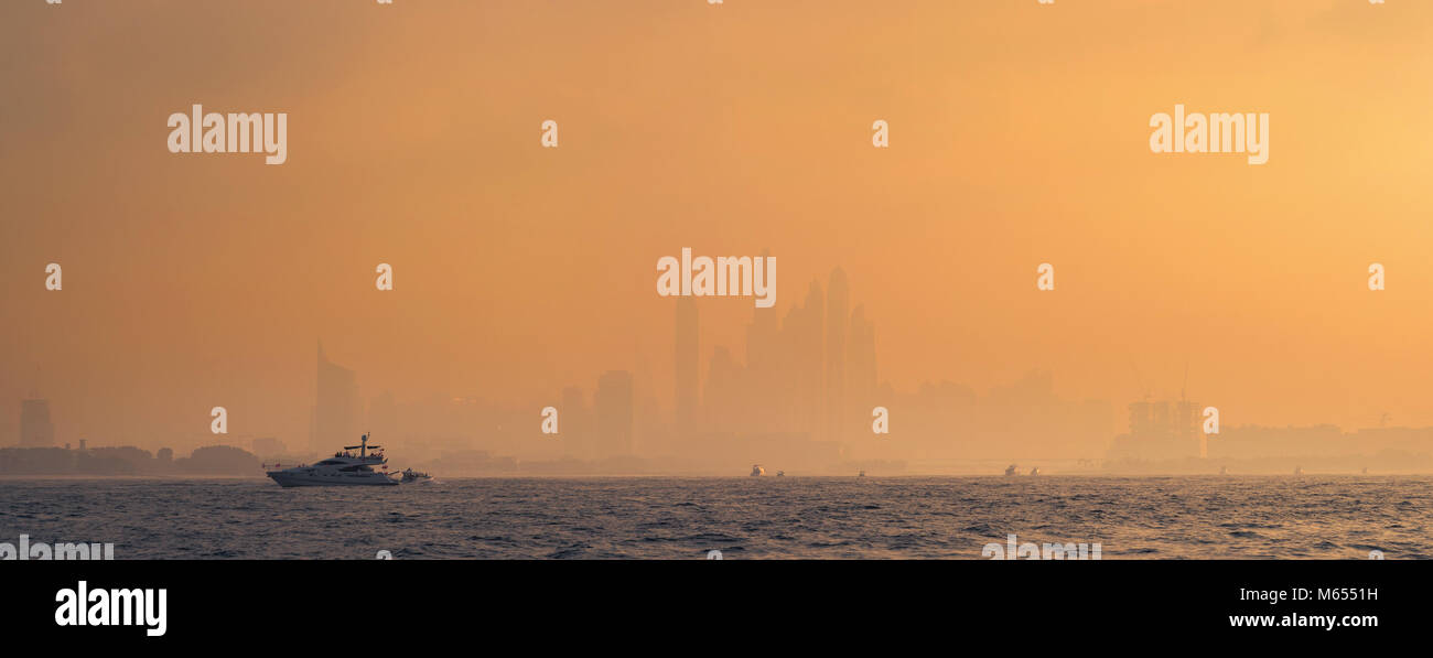 Golden sunset colors. Marina towers in the distance,  Dubai. Stock Photo