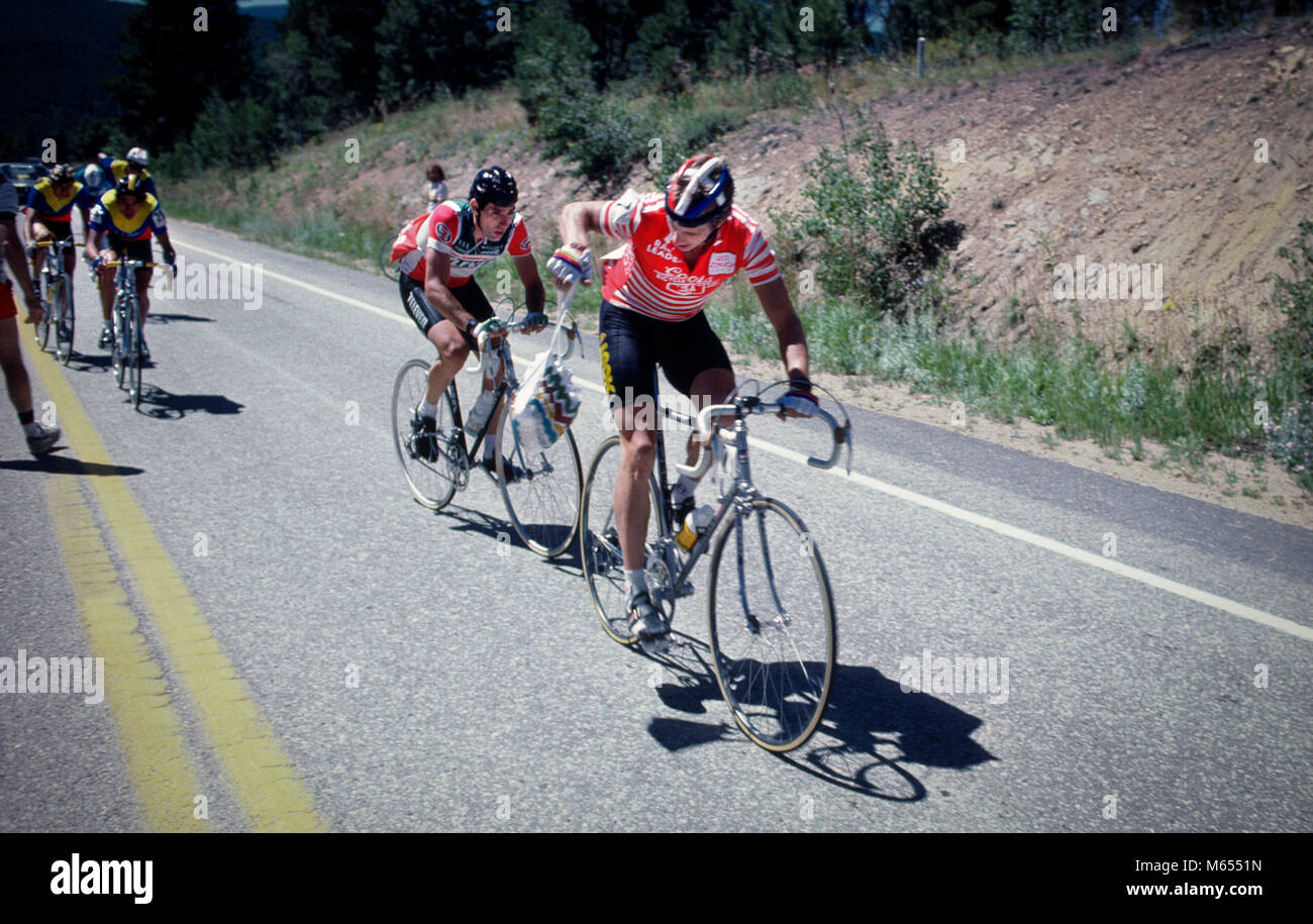 American Greg LeMond, right, getting a musette of food while racing his ...