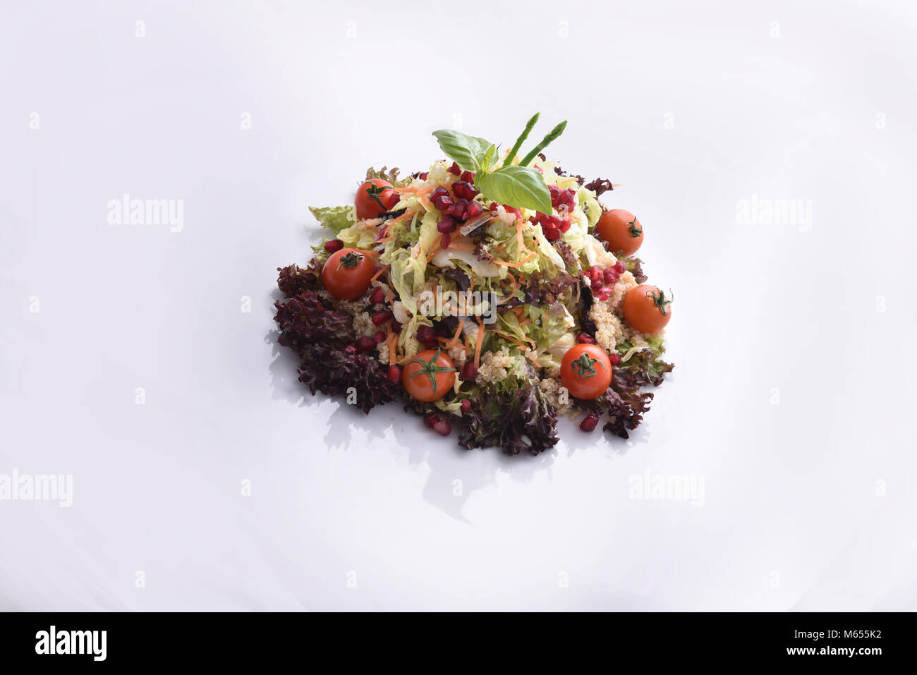 Quinoa salad with mixed vegetables and pomegranate Stock Photo