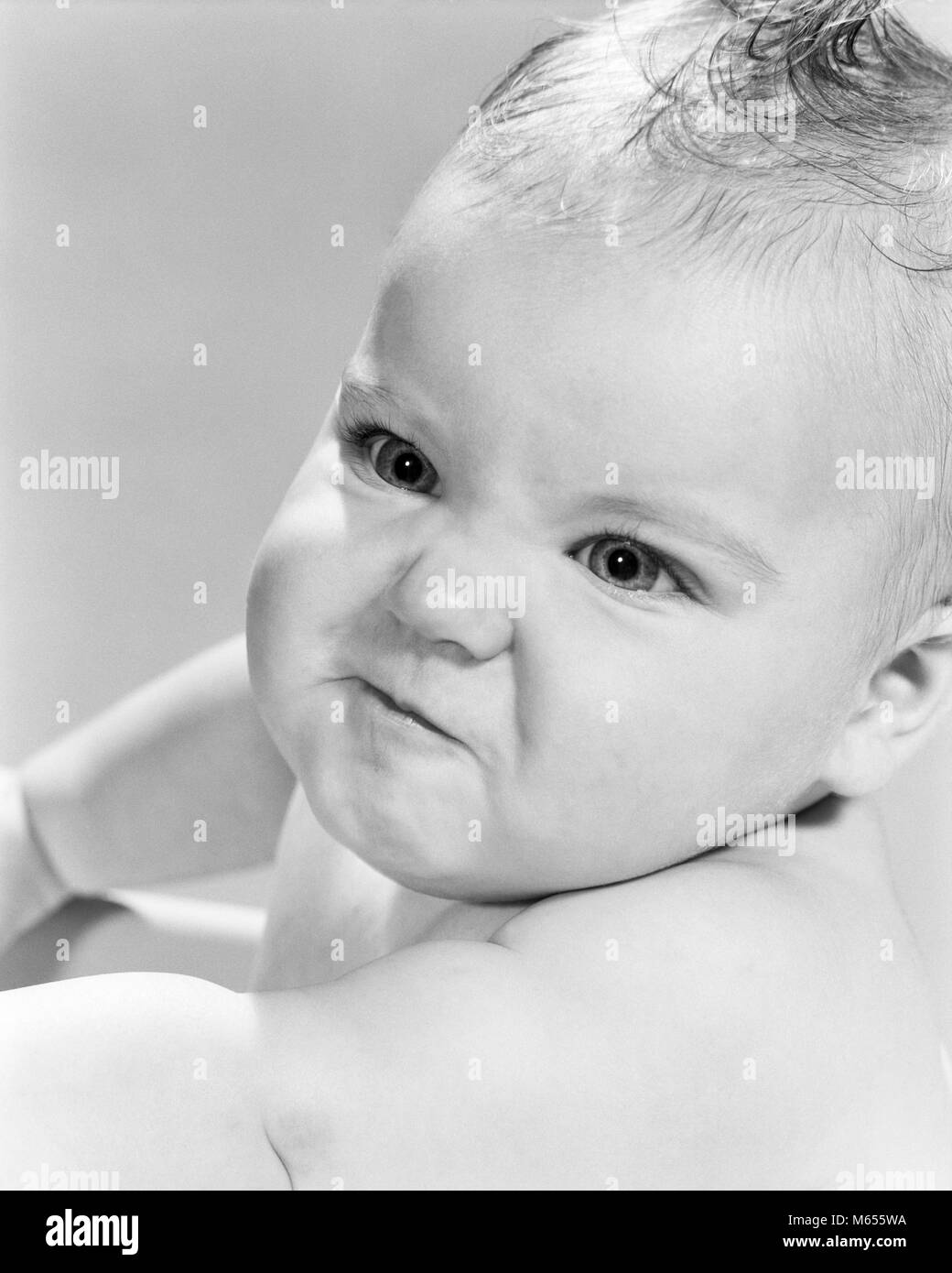 1950s 1960s BABY GIRL LOOKING ANGRY MAD MEAN - b12636 HAR001 HARS EMOTIONS INTENSE JUVENILES RESPONSE TOUGH AGGRESSION ATTITUDE B&W BABY GIRL BLACK AND WHITE CAUCASIAN ETHNICITY DEMEANOR HOSTILE OLD FASHIONED PERCEIVED PROVOCATION WRATH Stock Photo