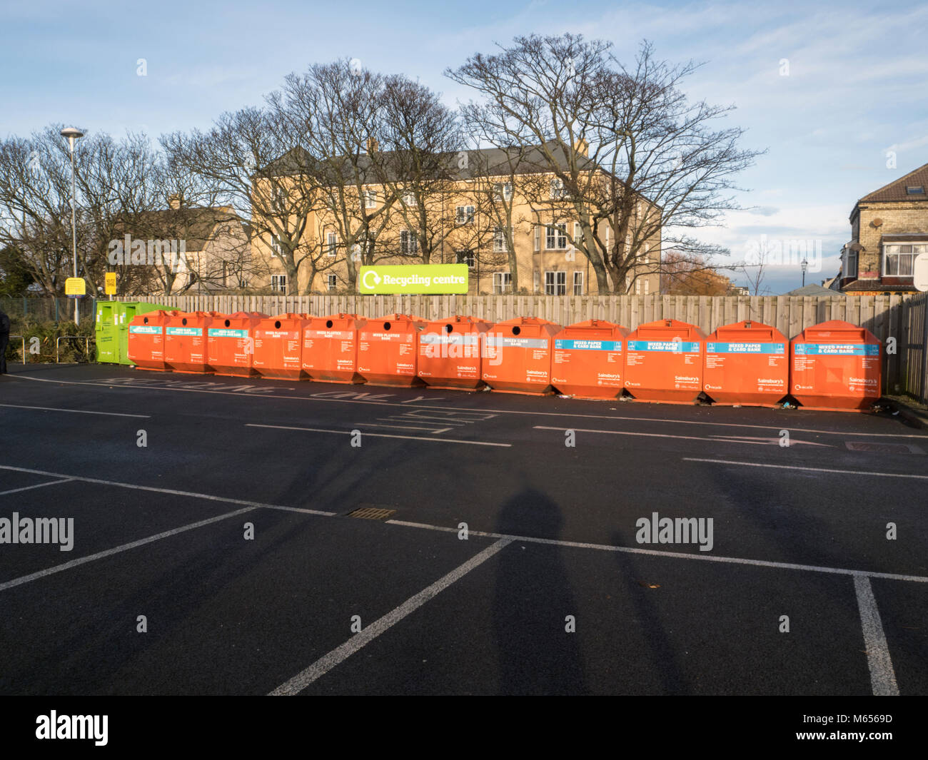 Row of recycling bins in super market car park near residential property Stock Photo