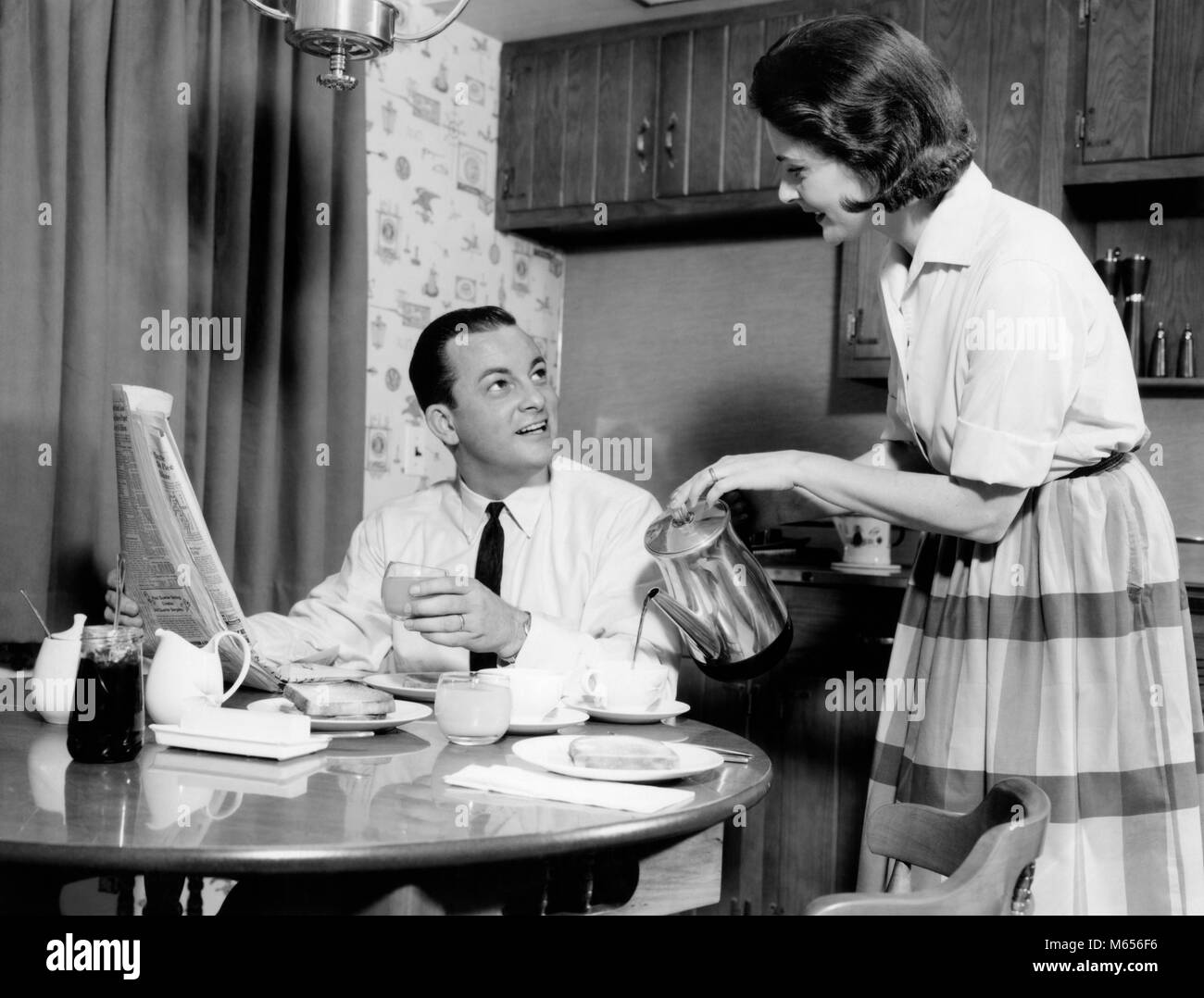 1960s WIFE POURING BREAKFAST COFFEE FOR HUSBAND DRINKING JUICE READING MORNING NEWSPAPER - d3400 HAR001 HARS SPOUSE HUSBANDS HEALTHINESS HOME LIFE COPY SPACE FRIENDSHIP HALF-LENGTH LADIES CARING COUPLES INDOORS NOSTALGIA MORNING TOGETHERNESS 30-35 YEARS 35-40 YEARS HOMEMAKER WIVES HAPPINESS HOMEMAKERS CHEERFUL HOUSEWIVES SMILES CONNECTION JOYFUL MALES MID-ADULT MID-ADULT MAN MID-ADULT WOMAN READS B&W BLACK AND WHITE CAUCASIAN ETHNICITY JUICE OLD FASHIONED PERCOLATOR PERSONS POURS WOMEN TABLE Stock Photo