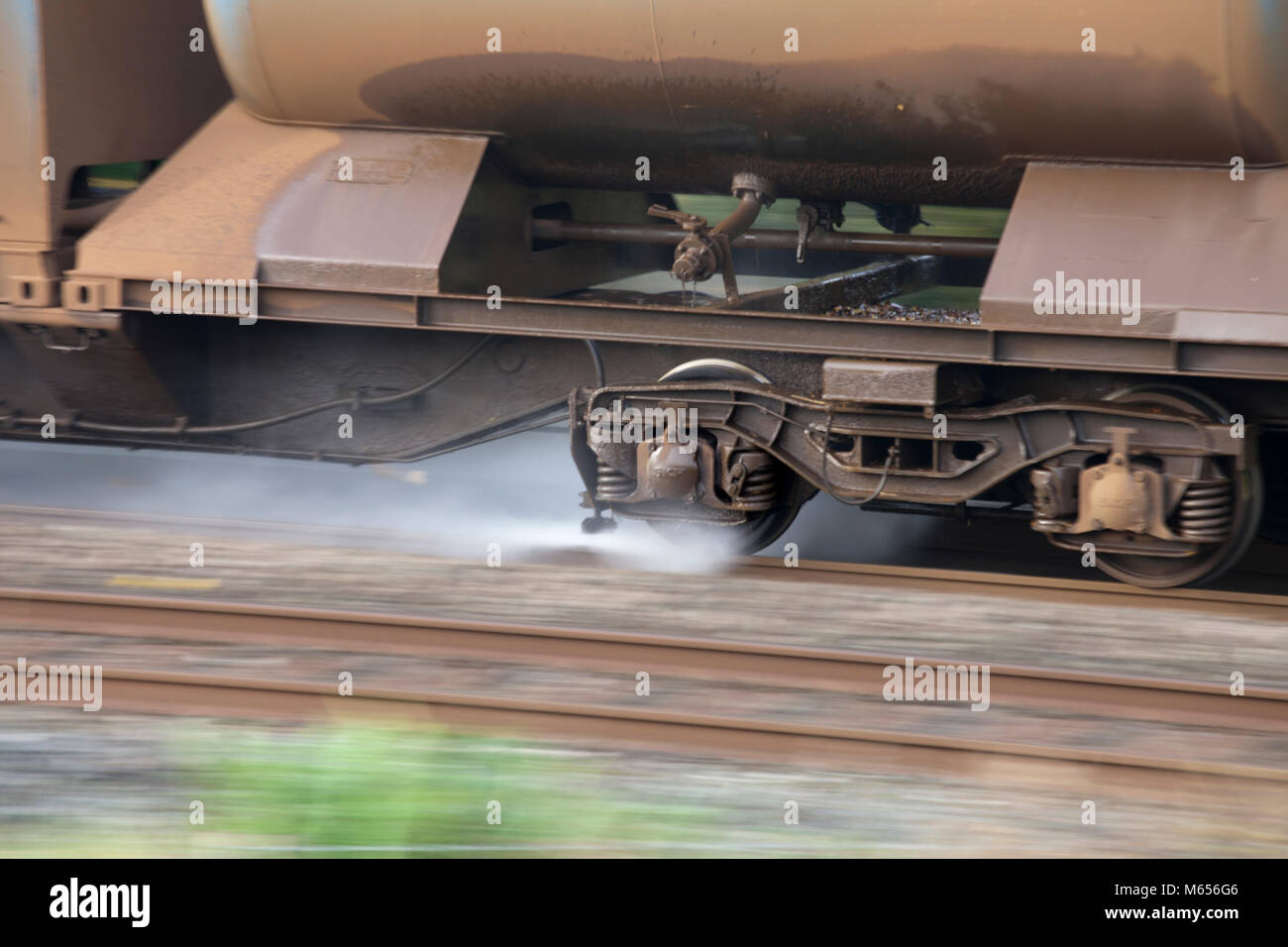 WATER JET SPRAYING FROM A NETWORK RAIL RAILHEAD TREATMENT TRAIN (WATER CANNON)  WASHING LEAF MULCH FROM THE SLIPPERY RAILHEAD IN AUTUMN Stock Photo