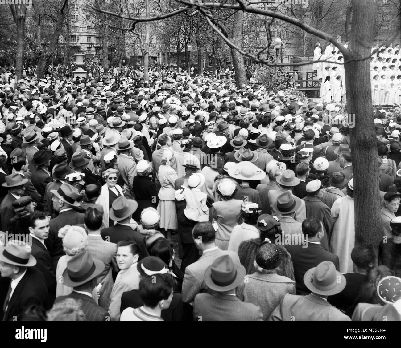 1950s EASTER SUNDAY CROWD RITTENHOUSE SQUARE PHILADELPHIA PENNSYLVANIA USA - e488 HAR001 HARS SPIRITUALITY NOSTALGIA HISTORIC HIGH ANGLE PA PARKS RITTENHOUSE REAR VIEW CONNECTION CITIES BACK VIEW JUVENILES MALES SPRINGTIME B&W BLACK AND WHITE CAUCASIAN ETHNICITY EASTER PARADE EASTER SUNDAY OLD FASHIONED PERSONS Stock Photo