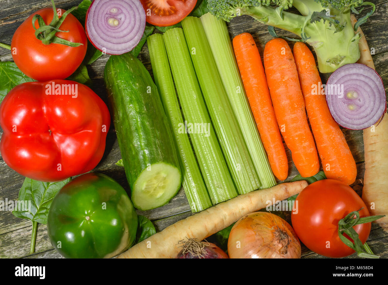 Colorful fresh group of vegetables for a balanced diet. Wooden ...