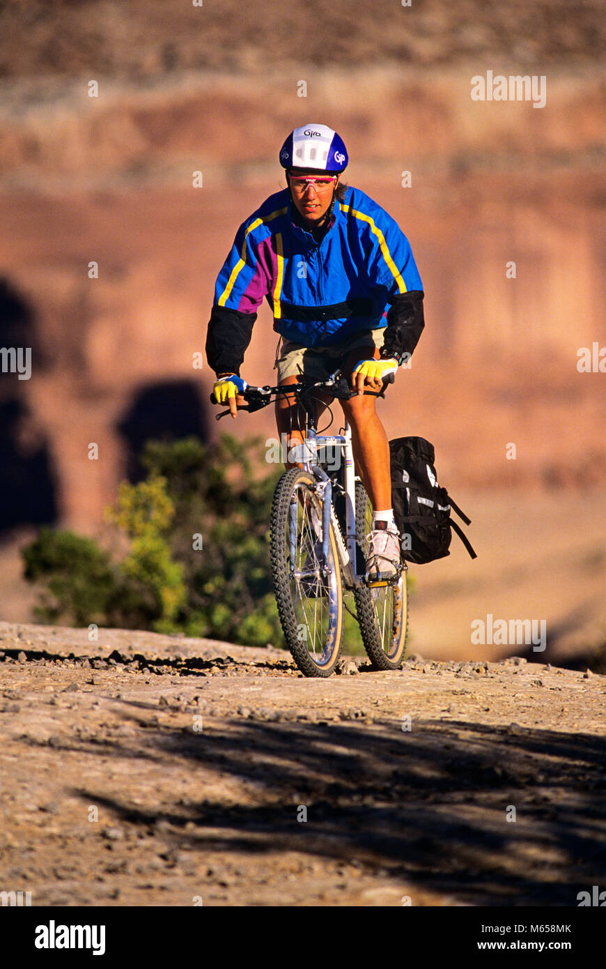 1990s YOUNG MAN RIDING BICYCLE MOAB UTAH USA - kb27705 WAL004 HARS YOUNG ADULT SAFETY RIDE CAUCASIAN ATHLETE CONTROL FIT LIFESTYLE BIKING RURAL TIRE HEALTHINESS ONE PERSON ONLY ATHLETICS NATURE UNITED STATES STRIPE COPY SPACE FULL-LENGTH PHYSICAL FITNESS UNITED STATES OF AMERICA WESTERN ATHLETIC ROUGH PEDAL EYEGLASSES TRANSPORTATION NOSTALGIA TRACTION EYE CONTACT 20-25 YEARS 25-30 YEARS DIRT ENERGY FREEDOM GOALS SINGLE OBJECT ACTIVITY PATH PURPLE PHYSICAL STRENGTHENING BRIGHT WEIGHT LOSS ADVENTURE PROTECTION SELF ESTEEM EFFORT RECREATION ROCKIES 1990s BICYCLING TERRAIN TRAIL MENTAL HEALTH Stock Photo