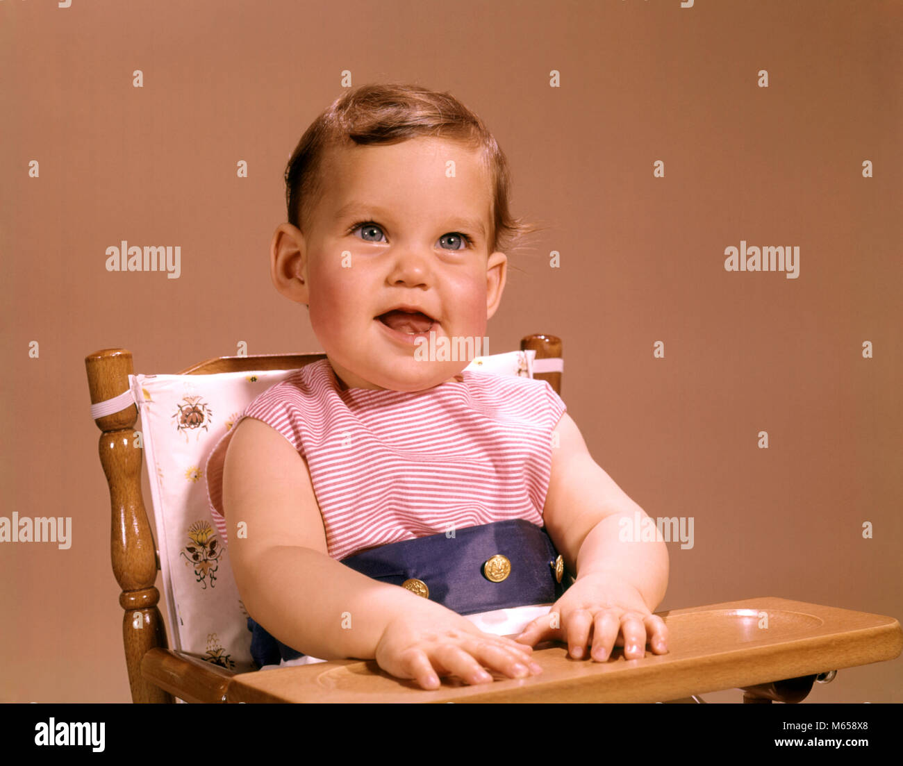 1960s BABY SITTING IN HIGHCHAIR SMILING LOOKING AT CAMERA kb4317