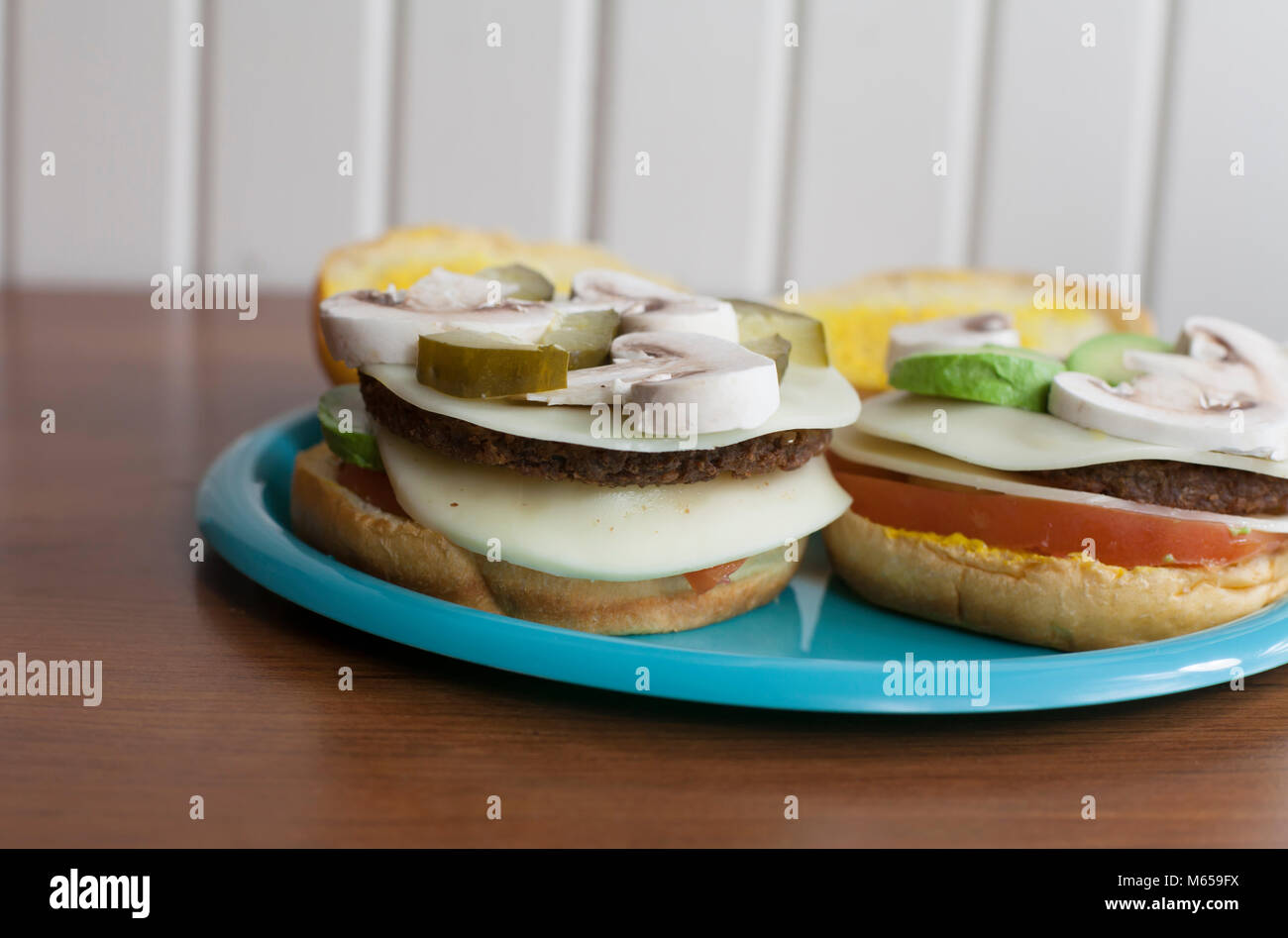 Mushrooms, pickles and provolone cheese on a veggie burger Stock Photo