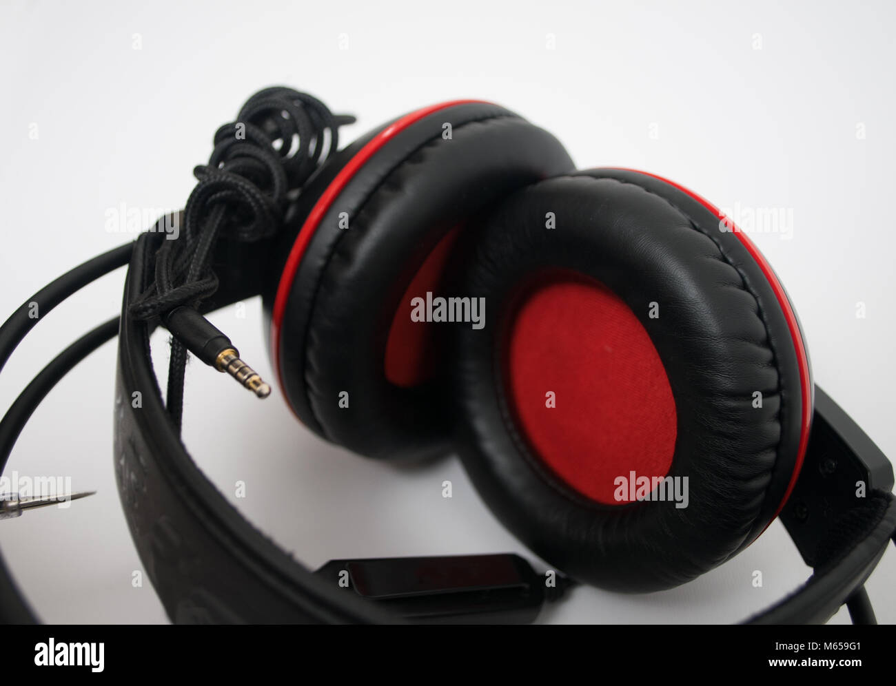 Black and red headphones on white background Stock Photo - Alamy