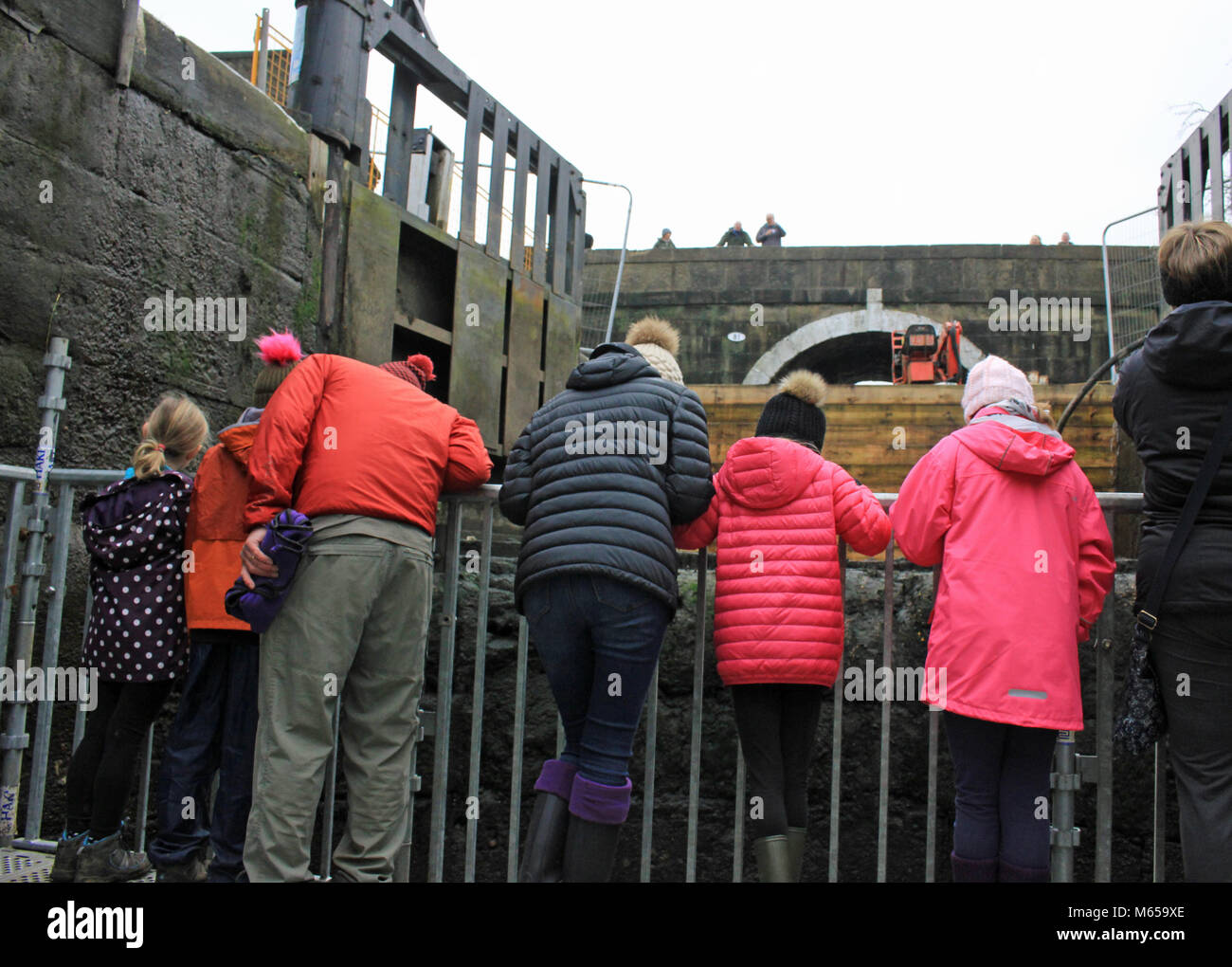 People in pink coats at a Canal and River Trust open day at Wheelton locks allowing members of the public to experience being in a empty lock chamber. Stock Photo