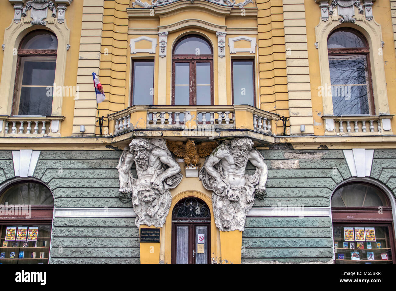 SUBOTICA, VOJVODINA, SERBIA: Front wall of the City Library with two Atlas figures supporting the balcony Stock Photo