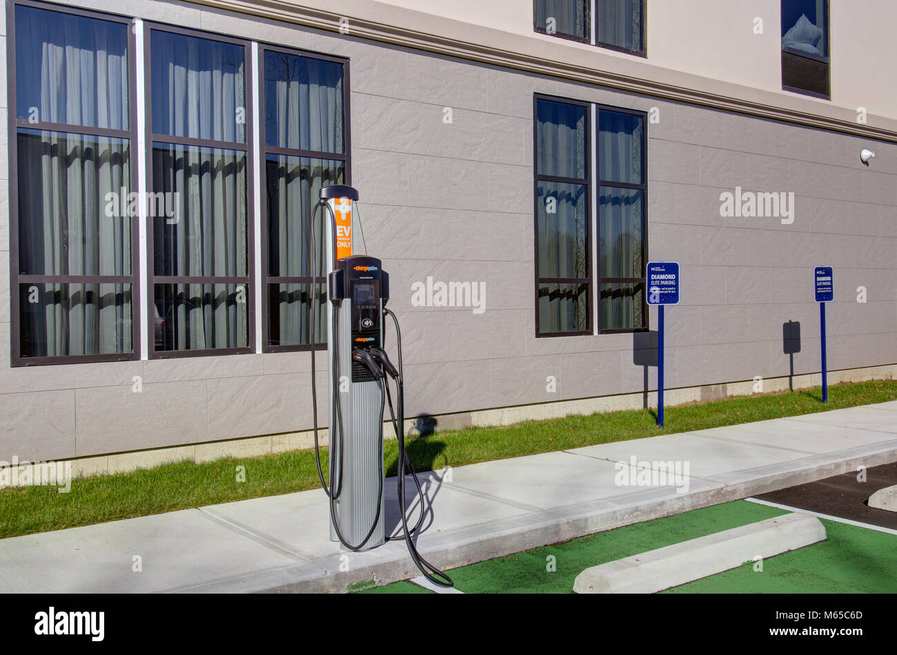 Electric Vehicle charging station in hotel parking lot Stock Photo