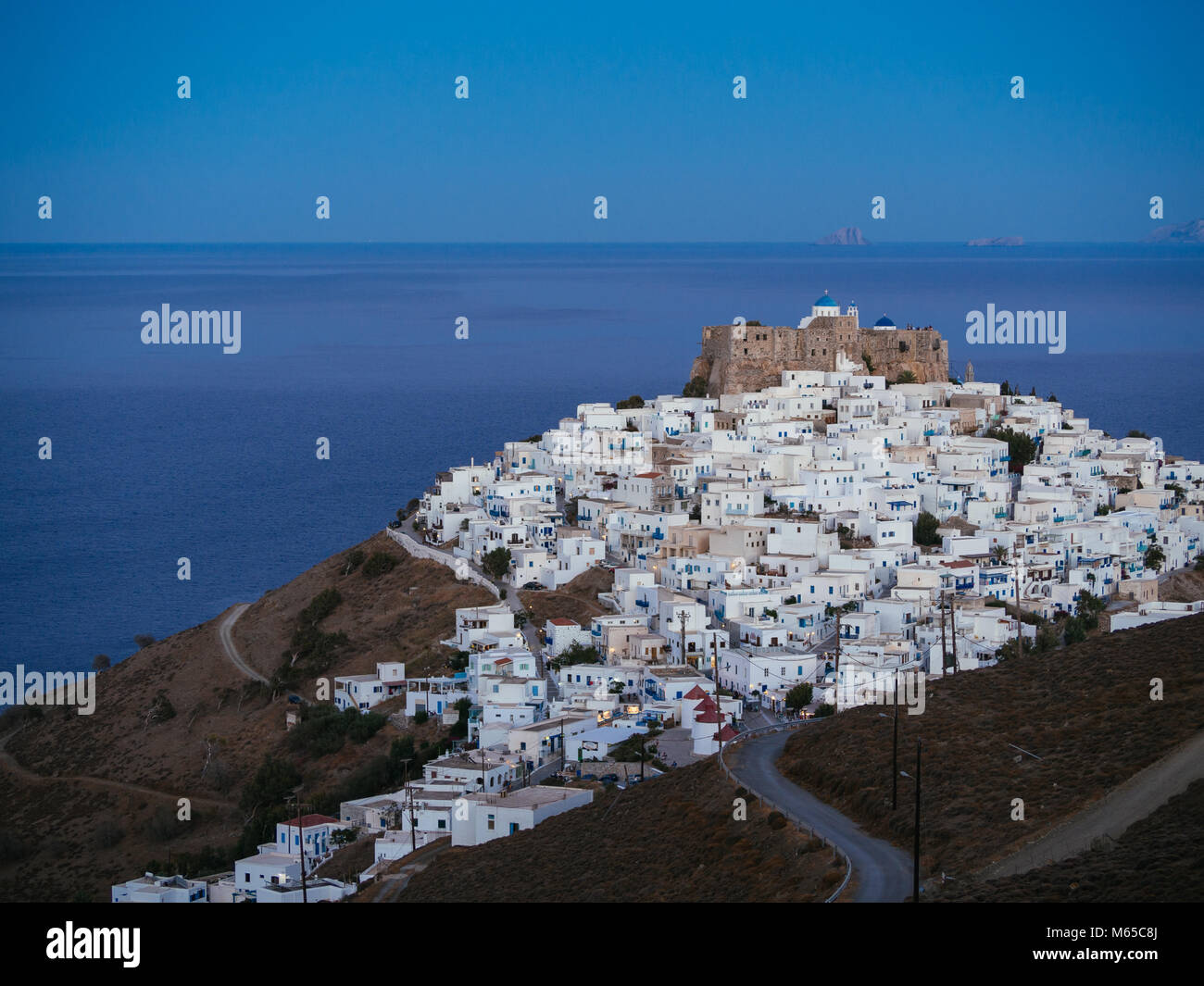 A lithe road leading to Chora of Astypalaia in blue hour Stock Photo
