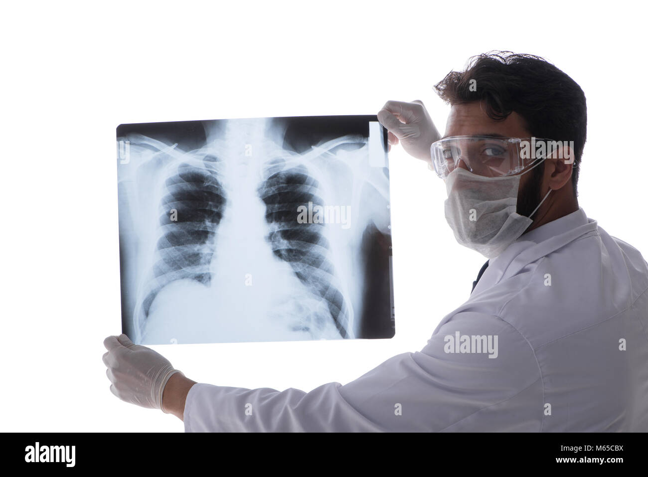 Young doctor looking at x-ray images isolated on white Stock Photo - Alamy