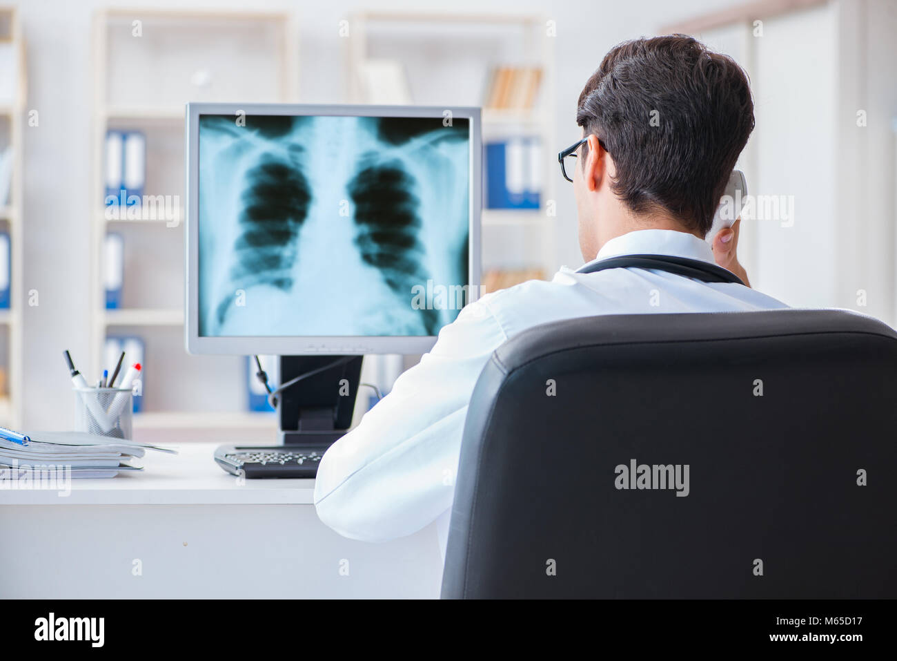 Doctor radiologist looking at xray images Stock Photo Alamy