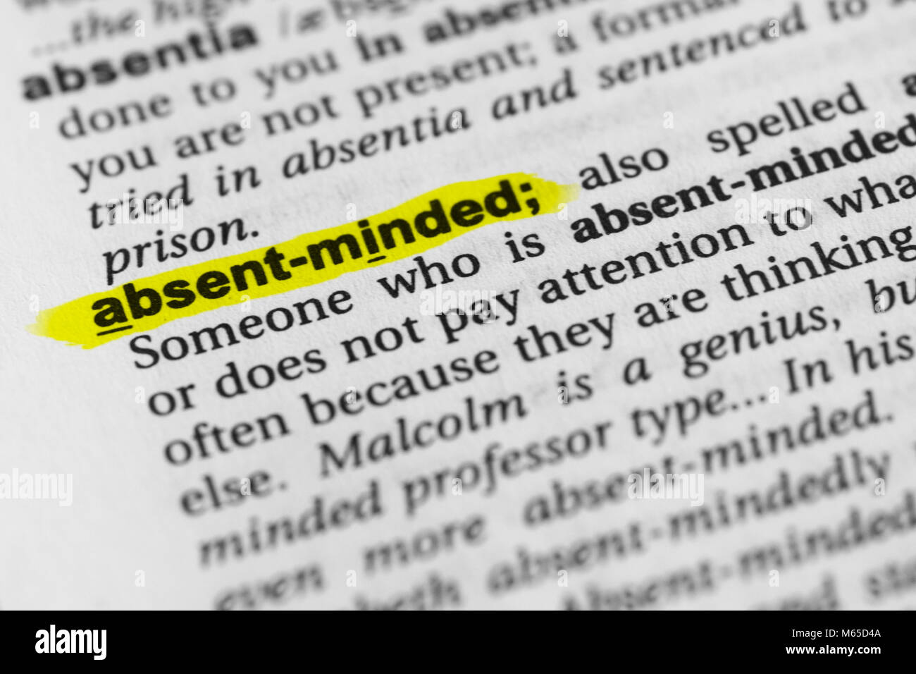 Highlighted English word 'absent-minded' and its definition in the dictionary. Stock Photo