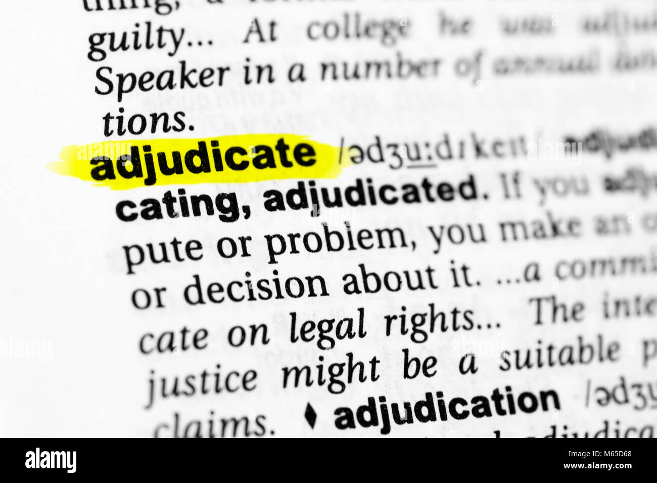 Highlighted English word "adjudicate" and its definition in the dictionary  Stock Photo - Alamy