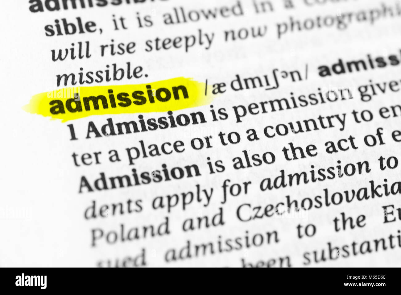 Highlighted English word 'admission' and its definition in the dictionary. Stock Photo