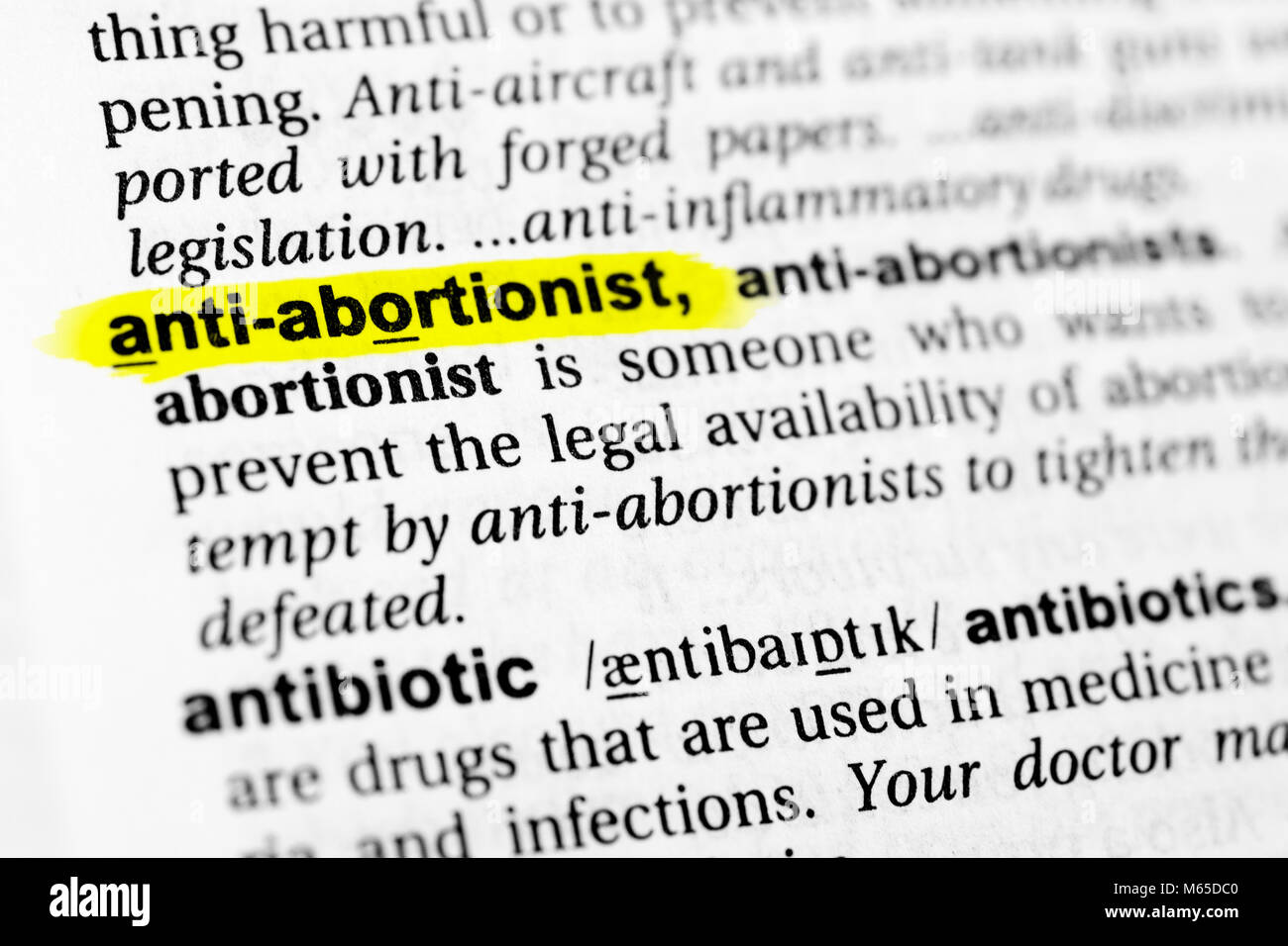 Highlighted English word 'anti abortionist' and its definition in the dictionary. Stock Photo