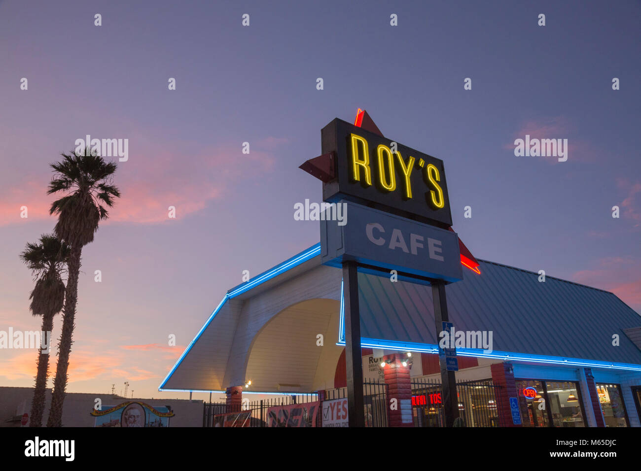 Neon-lit 'Roy's Café' sign with diner in Barstow, California. Stock Photo