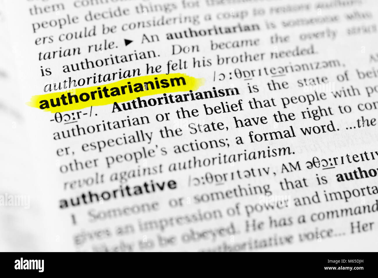 Highlighted English word 'authoritarianism' and its definition in the dictionary. Stock Photo