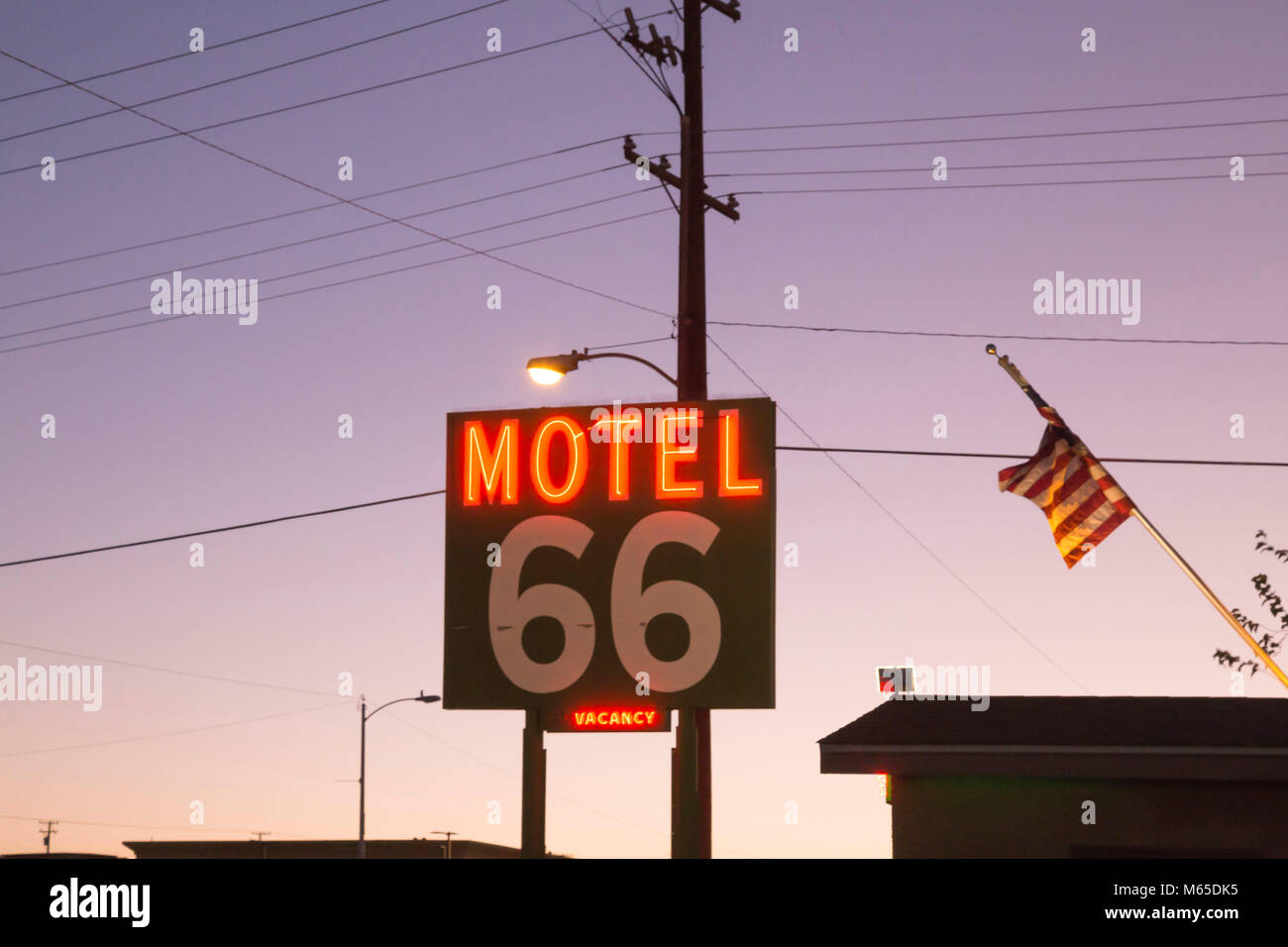 Illuminated neon sign of 'Motel 66' along Route 66 in Barstow, California. Stock Photo