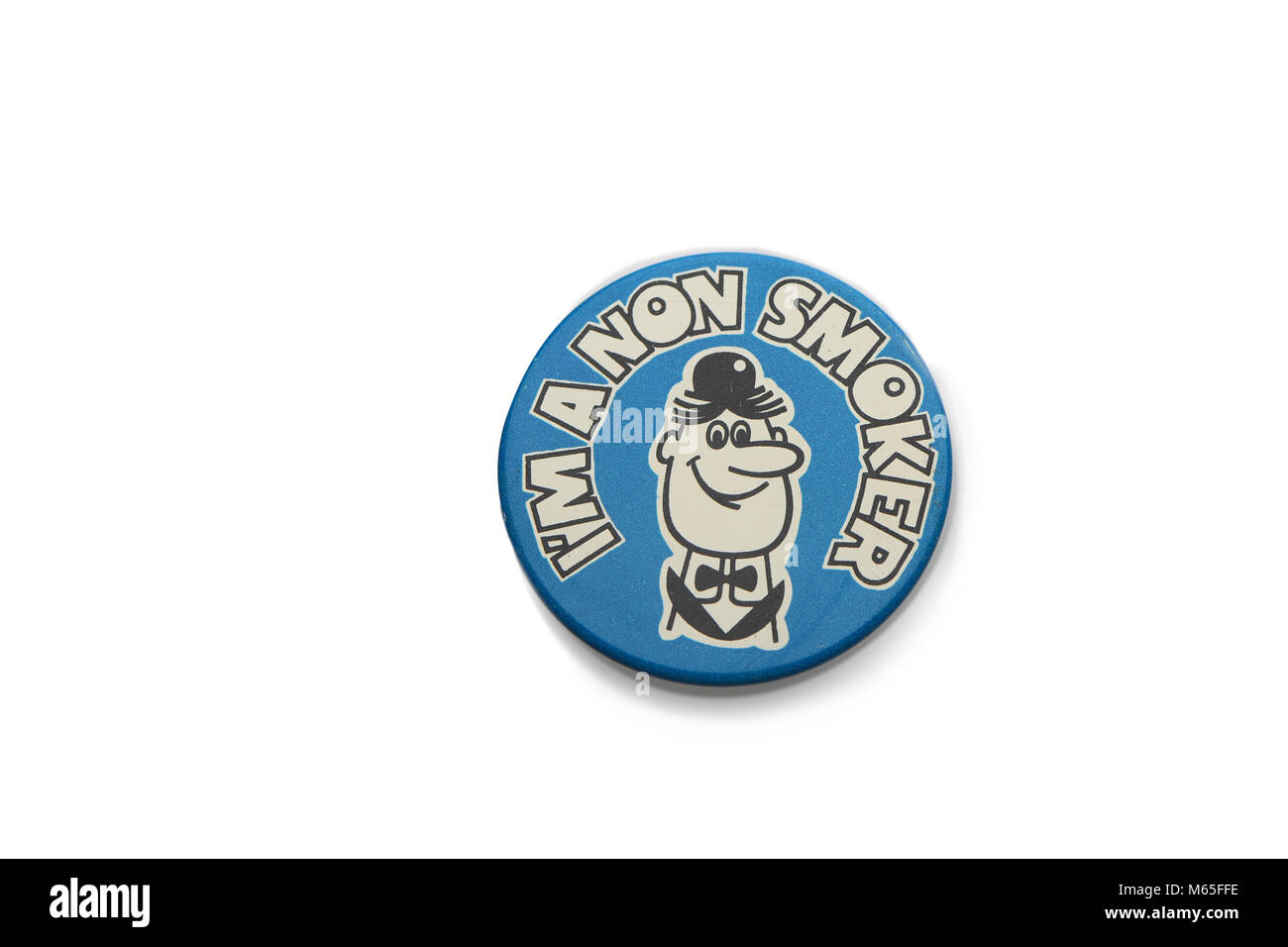 A 1970s era tin badge Im a non smoker collectable on a white background. Stock Photo