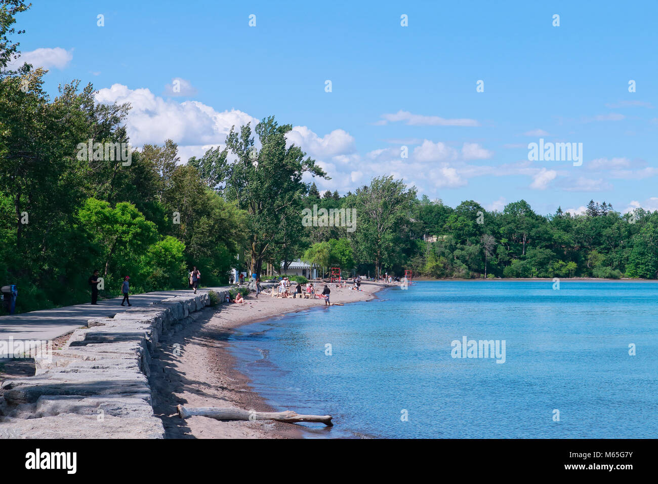 People and families with multi-racial backgrounds enjoying summer in sand beach and blue water in Rouge National Urban Park, Rouge Beach and Marsh Are Stock Photo