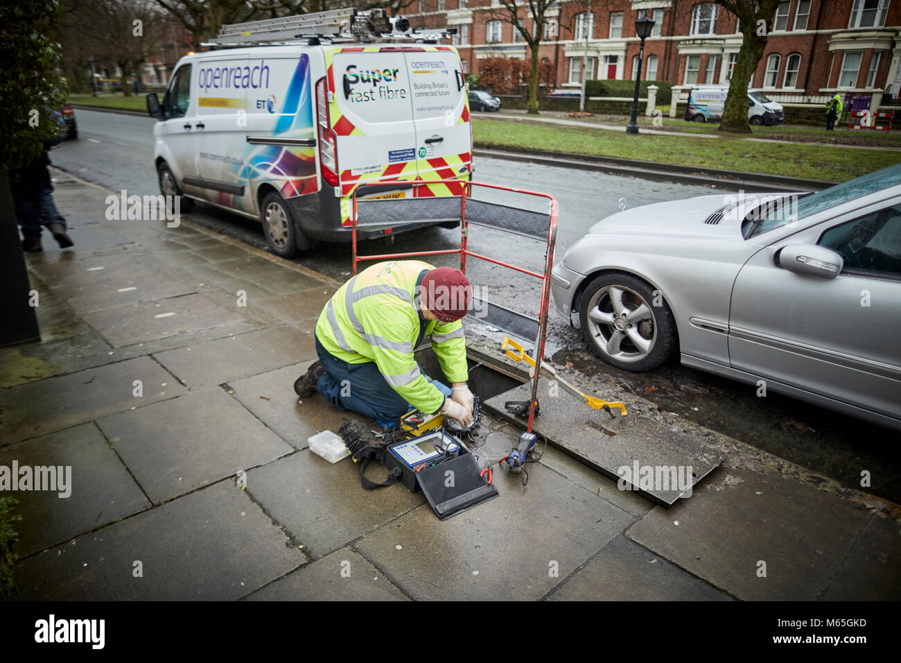 BT British telecom Openreach cable engineer workman working in the street at an open manhole Stock Photo