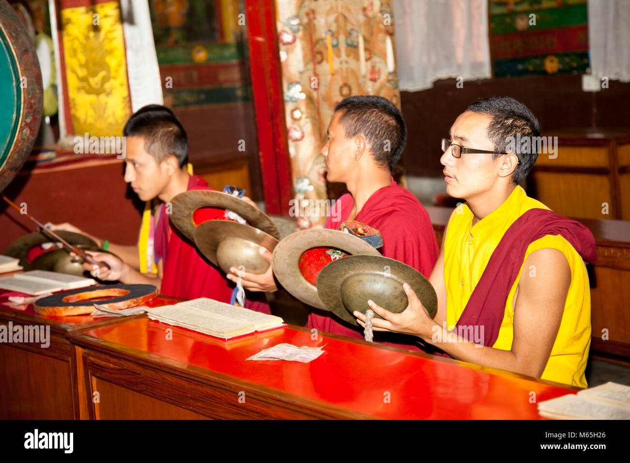KATHMANDU, NEPAL - MAY 18: Unidentified young Buddhist monks play music during the praying in Bouddanath Stupa on May 18, 2013 in Kathmandu, Nepal. Stock Photo
