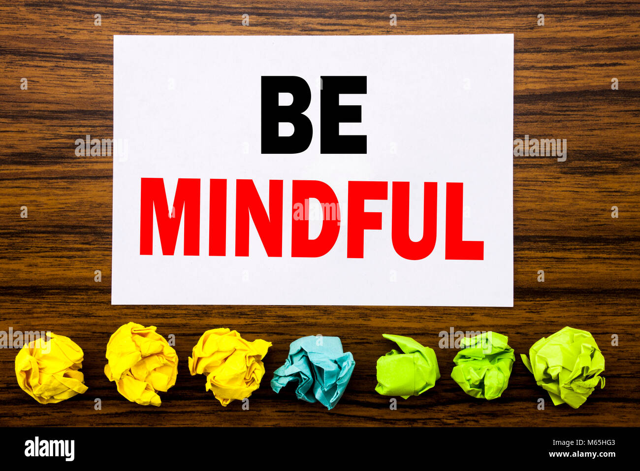 Hand writing text caption inspiration showing Be Mindful. Concept for Mindfulness Healthy Spirit Written on sticky, with sticky, one folded paper alon Stock Photo