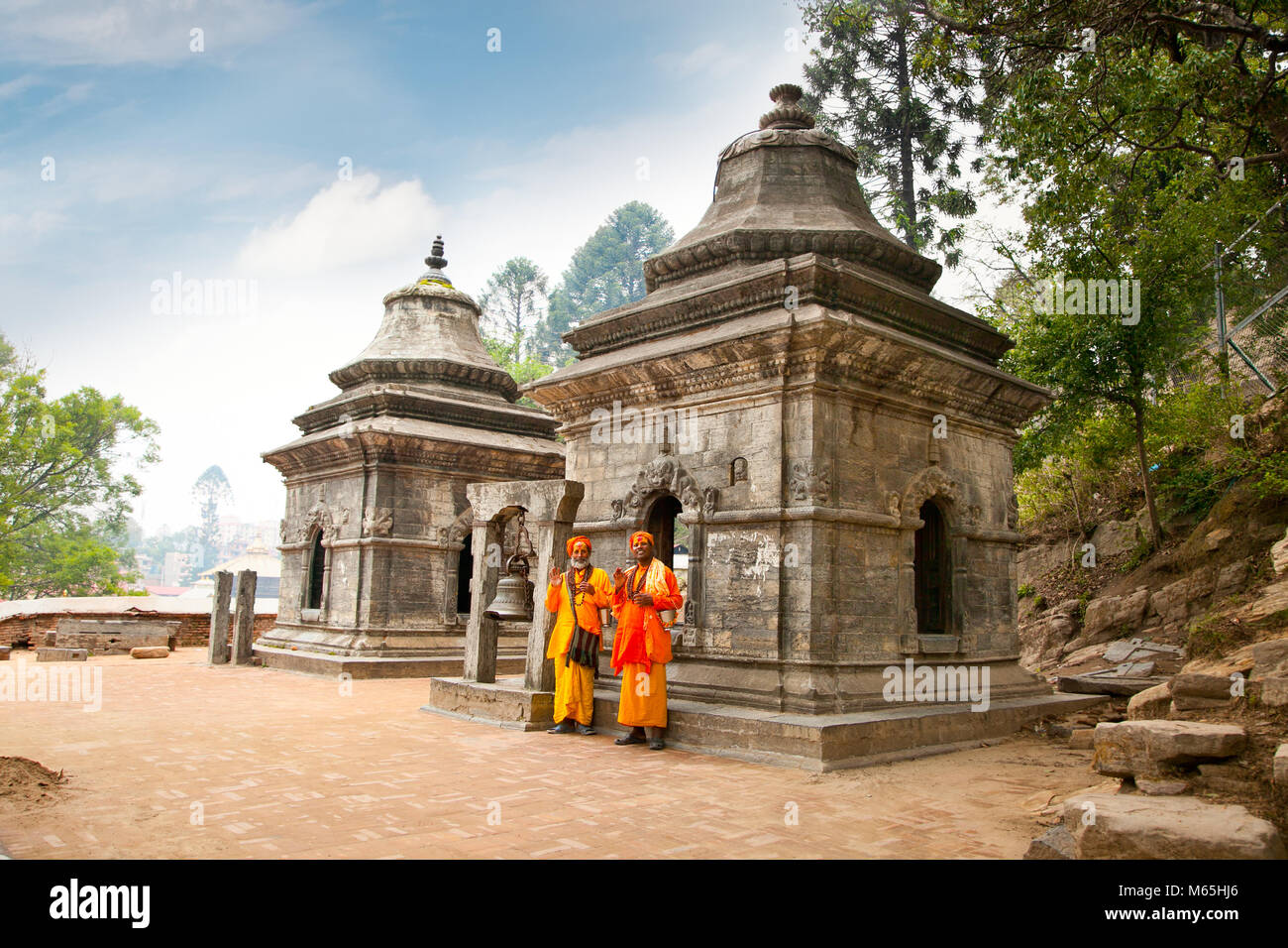 KATHMANDU, NEPAL - MAY 18: Holy Sadhu men with traditional painted face, blessing infront of Eighteen Shivalaya in Pashupatinath Temple. May 18, 2013. Stock Photo