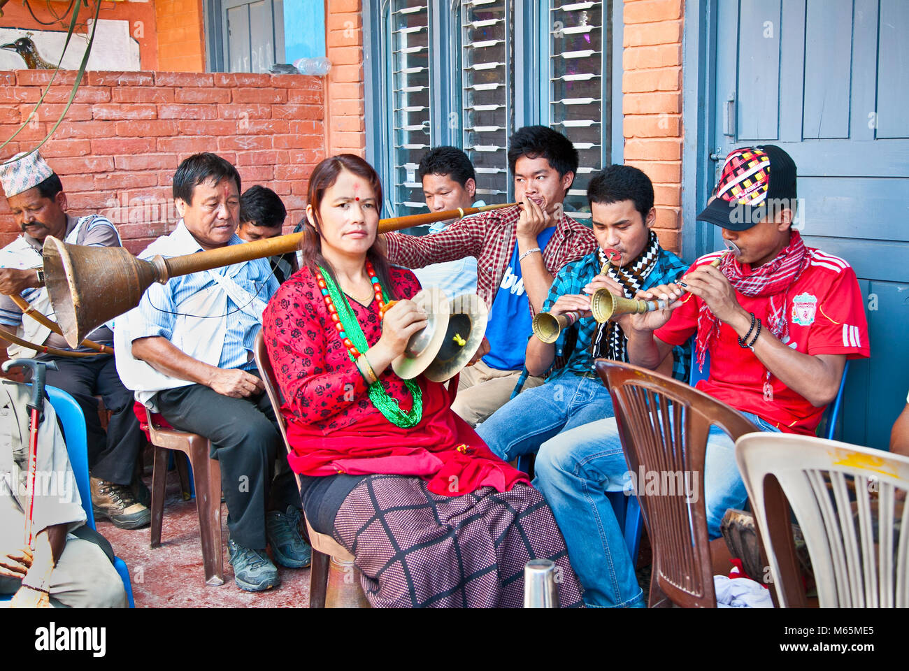 POKHARA, NEPAL-MAY 25. 2013: An unidentified Nepalese musicians play brass traditional instrumet on May 25, 2013 in Pokhara, Nepal. Pokhara is located Stock Photo