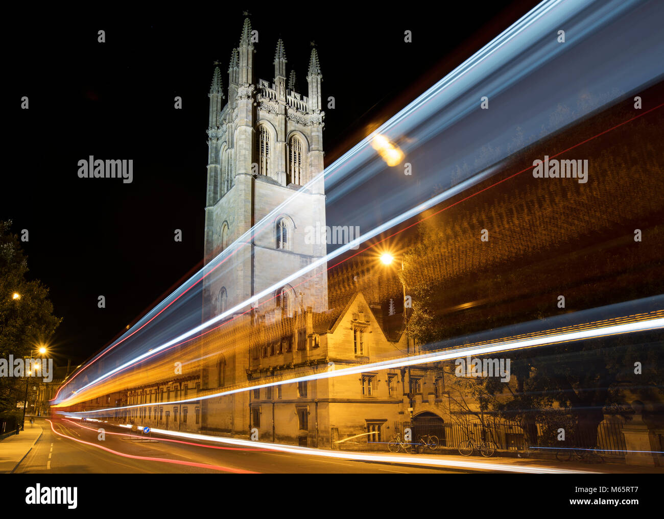 Magdalen college and bus trail lights at night. Oxford, Oxfordshire, England Stock Photo