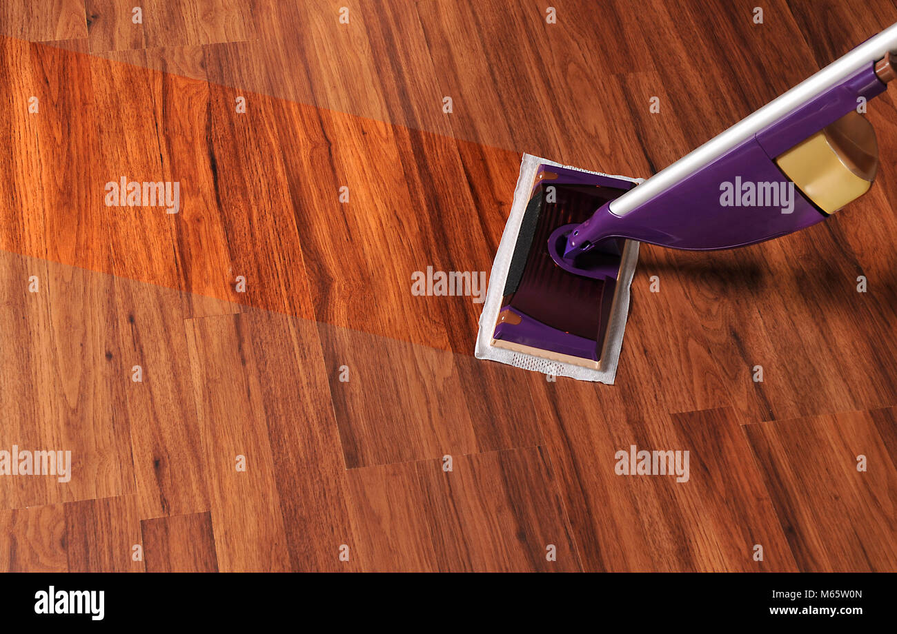 Modern mop for cleaning wooden floor from dust, cleaning service Stock