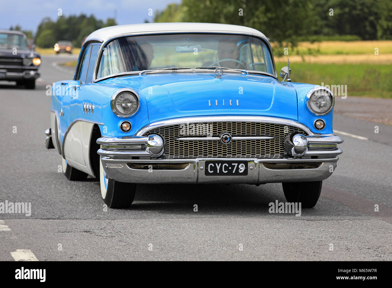 SOMERO, FINLAND - AUGUST 5, 2017: Classic blue and cream Buick Special 4-door sedan, circa 1955, moves along rural highway on Maisemaruise 2017 car cr Stock Photo