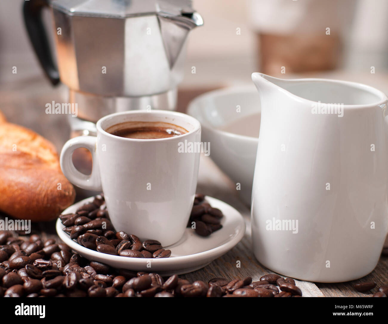 Cup of coffee, coffee beans on wood table Stock Photo - Alamy