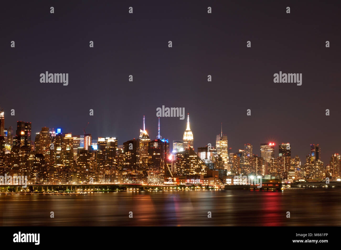 New York City - Panoramic view of Manhattan at night with reflection in ...