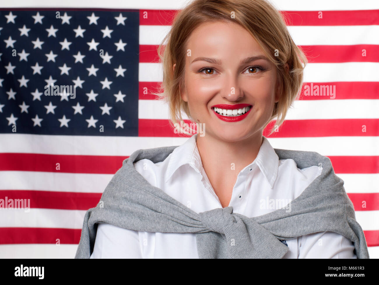 American flag Smiling young man on United States flag background USA