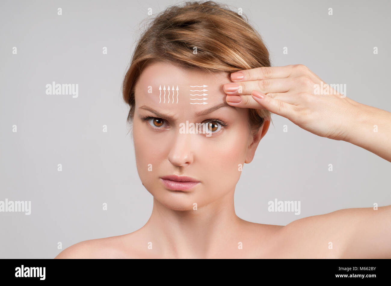 Face of woman with perfectly clean skin and massage facial lines on