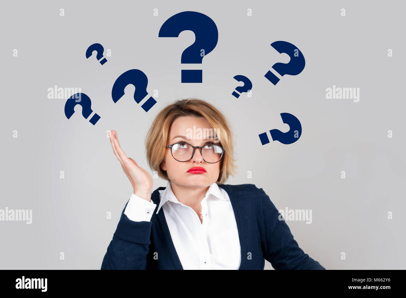 Thinking woman with questioning expression and question marks above her ...