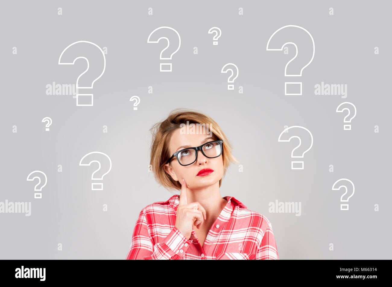 Thinking woman with questioning expression and question marks above her ...