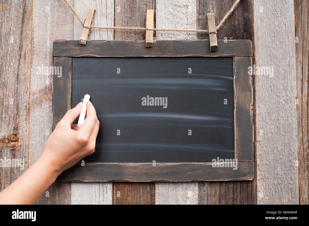 Female hand to draw something on blackboard with chalk Stock Photo Alamy