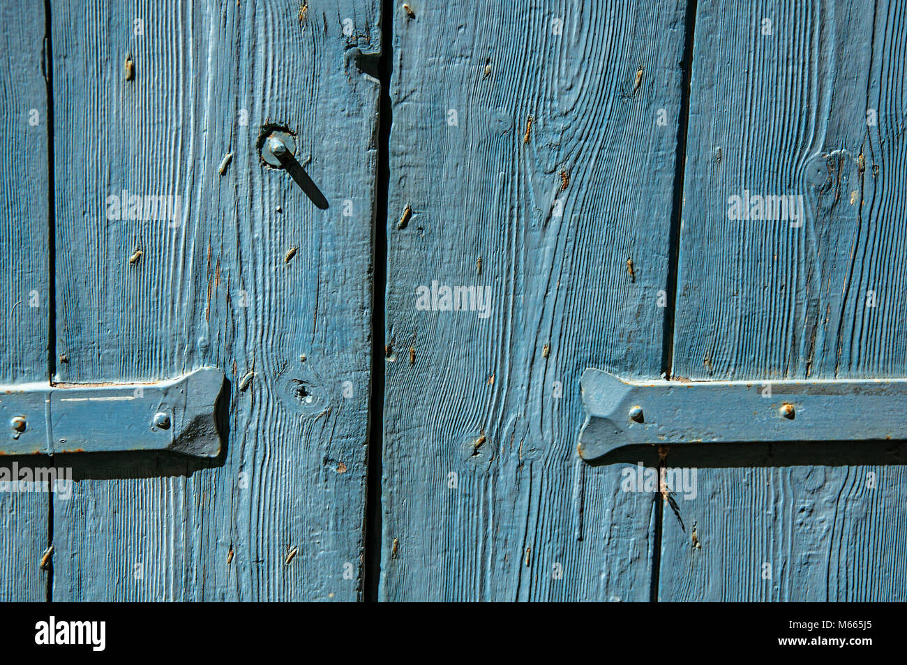 Close Up Of Wooden Door And Hinge Painted Blue In The Village Of
