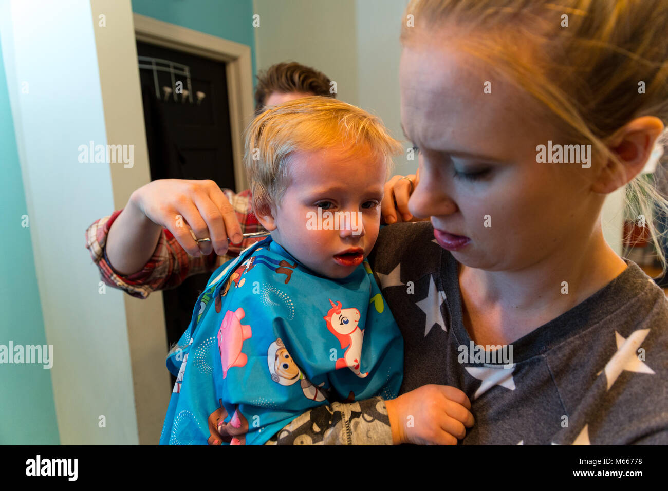 Caucasian Toddler Boy Has His Hair Cut By A Barber As His Mom Watches Stock  Photo - Alamy