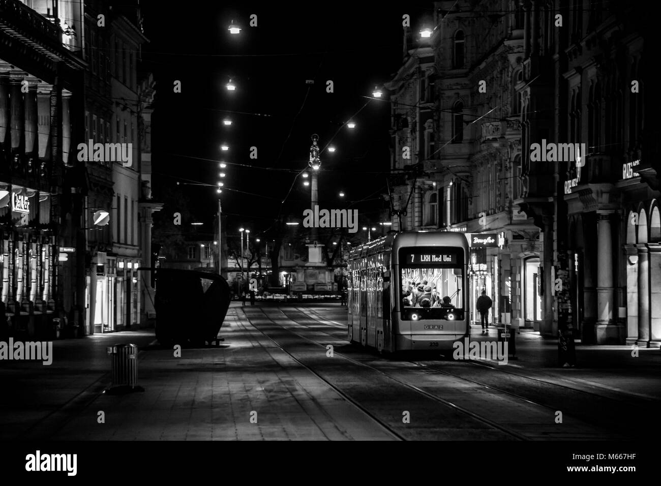 Graz, Austria - 08.02.2018: Black and white picture of the No. 7 tram heading down the Herrengasse at night Stock Photo